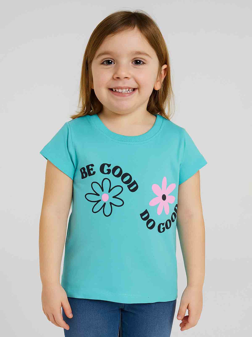 Child wearing a turquoise t-shirt with 'Be Good Do Good' text and flower graphics on a plain background