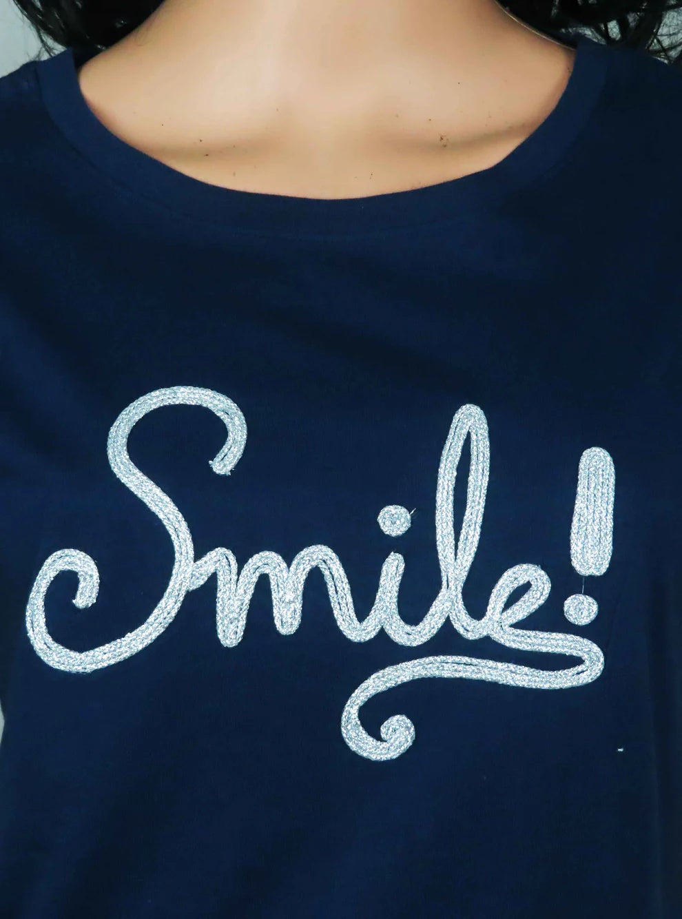 Navy blue shirt with 'Smile!' text in white on a plain background