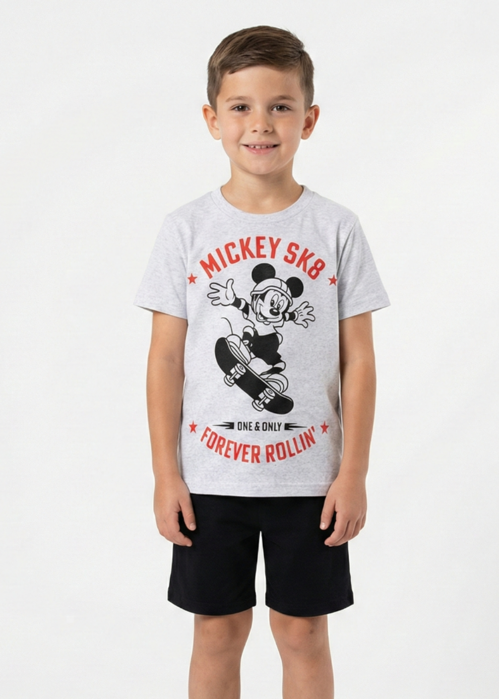 Child wearing a gray t-shirt with a graphic design on a white background