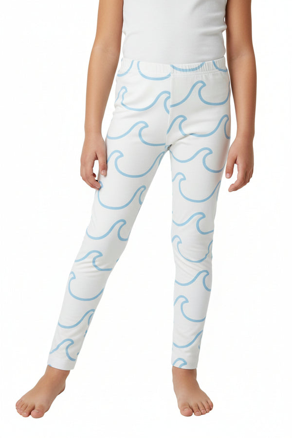 White pants with blue wave pattern on a red patterned fabric background