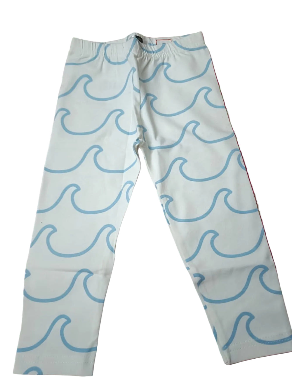 White pants with blue wave pattern on a red patterned fabric background