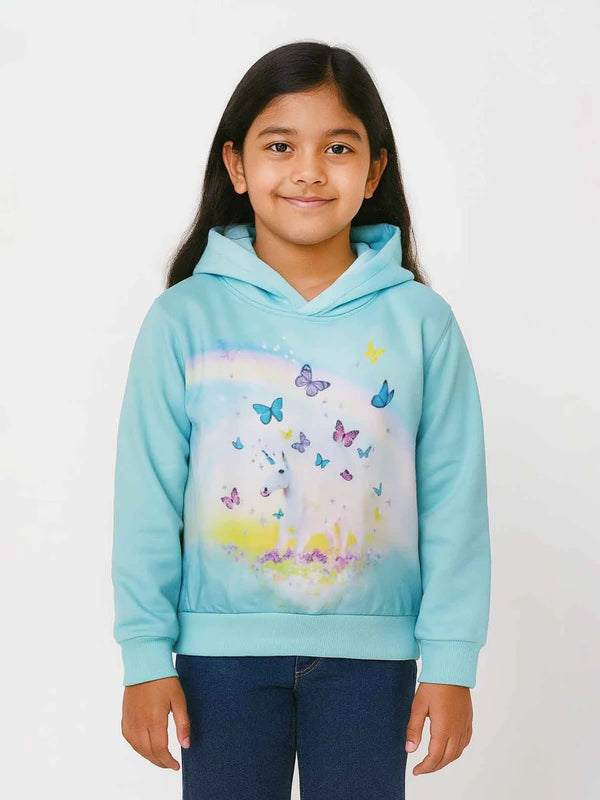 Girl wearing a light blue hoodie with butterfly design on a white background
