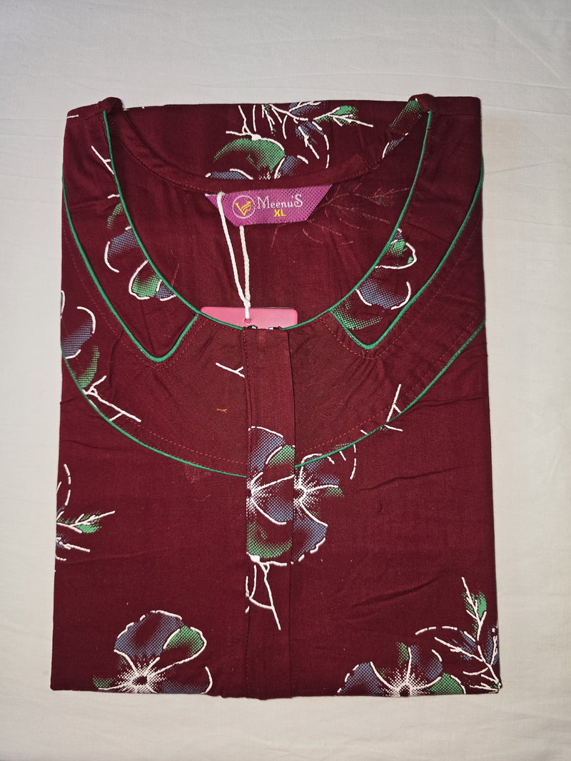 Maroon top with floral patterns on a light gray background