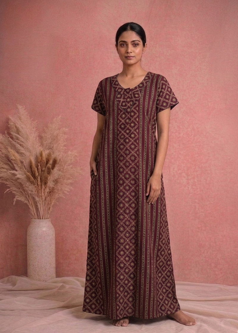 Woman wearing a patterned dress standing against a pink background with decorative elements.