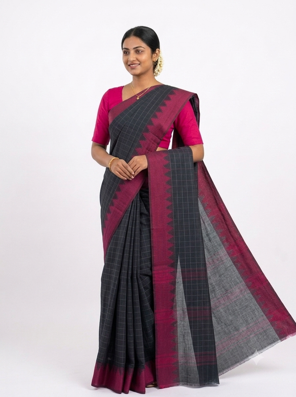A woman modeling a dark gray and magenta saree with a matching magenta blouse, set against a plain white studio background.