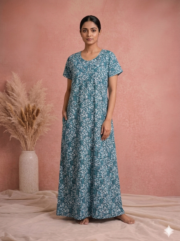 Woman wearing a blue floral dress against a pink background