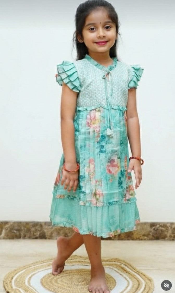 Young girl wearing a floral dress with a plain background