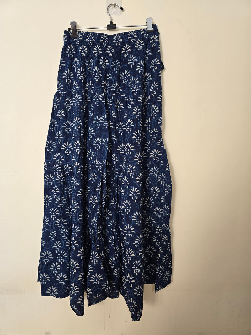 Folded blue fabric with white patterns on a beige background