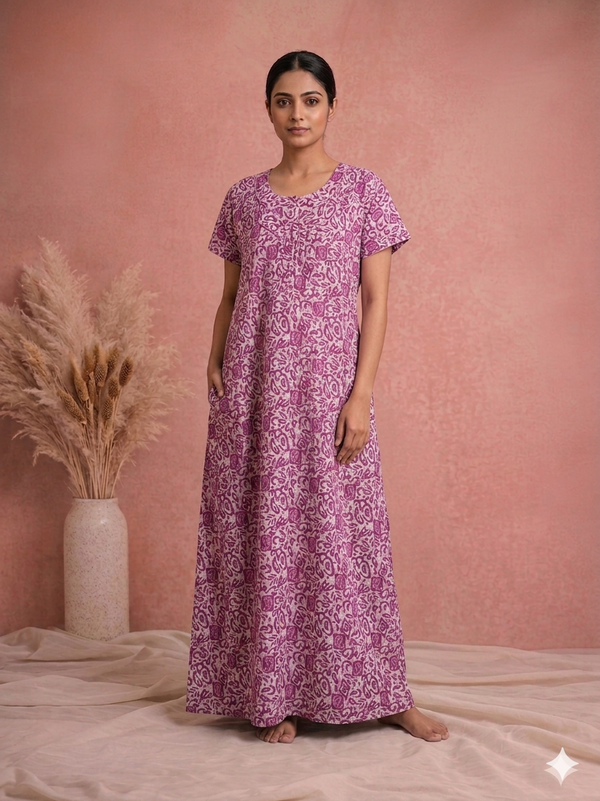 Woman wearing a purple floral dress against a pink background